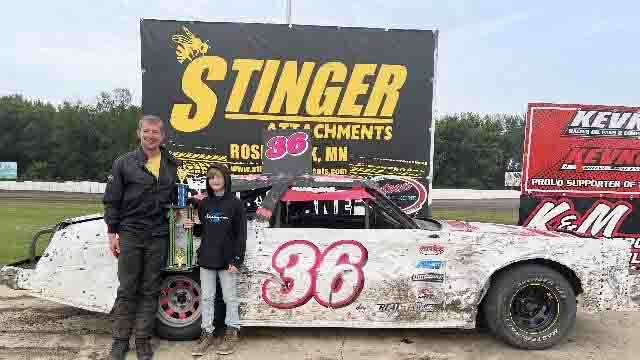 Andy Krohnberg holding trophy in victory lane at SMP Enduro Racing after competing in the Full-Size Class in Southern Minnesota.