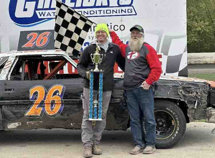 Brady Krohnberg holding trophy in victory lane at SMP Enduro Racing after competing in the Full-Size Class in Southern Minnesota.