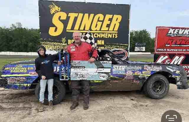 Stacy Krohnberg holding trophy in victory lane at SMP Enduro Racing after competing in the Full-Size Class in Southern Minnesota.